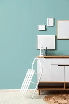 Interior of room with commode, sled and blank frames Fotos Stock