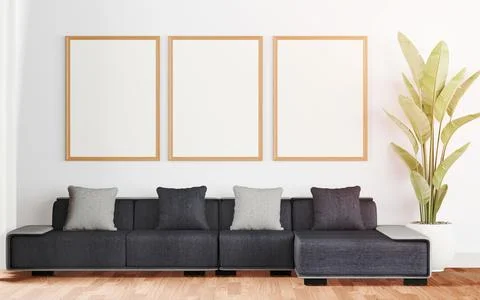 Interior room featuring three white frames hanging above a gray couch, with copy Stock Photos