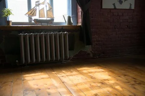 Interior of the room with a ship model on the windowsill and wooden floor 스톡 사진