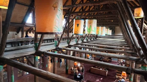 Interior of rustic timber lodge with hanging lanterns and wooden beams Stock Footage 339117857