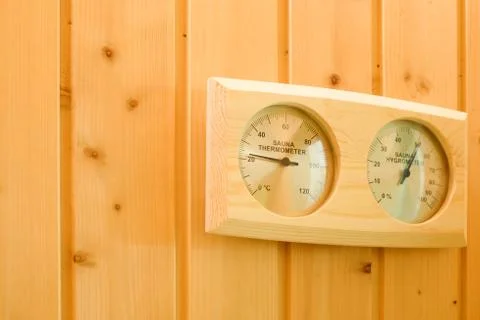 Interior of the sauna. Measurement of humidity and temperature by thermometer Stock Photos