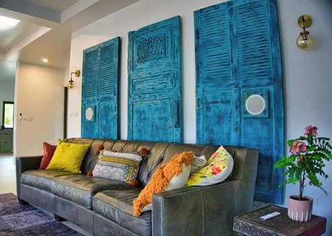 Interior Scene with Brown Leather Sofa and Wooden Doors Stock Photos