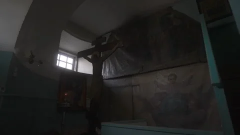 An interior scene featuring a beautifully crafted cross and religious murals Vidéo 303813841