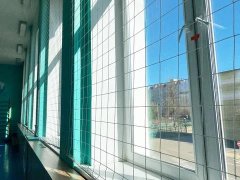 Interior of a school gym with large windows, bright natural light illuminating Stock Photos