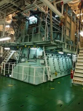 Interior of Ship's Engine Room with Complex Machinery and Controls Stock Photos