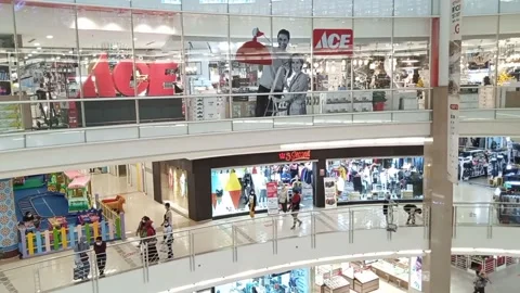 Interior of shopping mall in hall void area with people passing by and ace Stock Footage 147112112