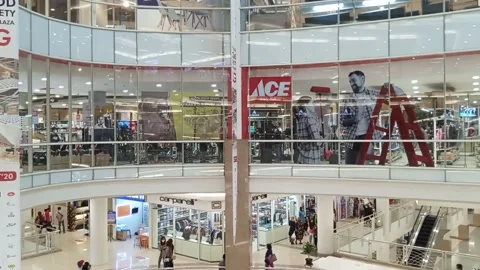 Interior of shopping mall in hall void area with people passing by and ace Video stock 147112157