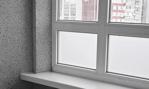 Interior shot of double-glazed white window in high-rise building. Urban ar.. Stock Photos