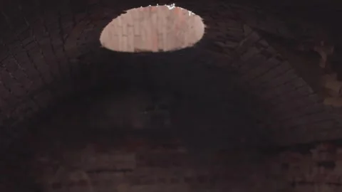 The interior showcases a circular opening in a classic brick archway, merging Stock Footage 312237024