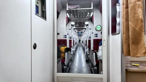Interior sleeper train aisle with bunks indicating overnight travel through Stock Footage 321211537