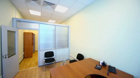 Interior of small empty office cabinet with black armchair Video stock 33295574