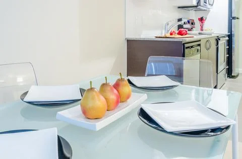 Interior of small white kitchen with fresh pears on the table Stock Photos
