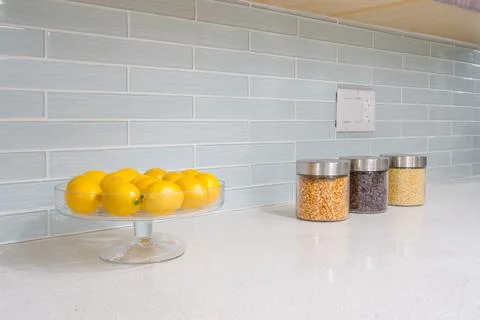 Interior of small white kitchen with yellow lemons on the table Stock Photos