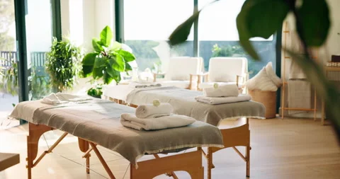 Interior, spa and bed for massage at resort, wellness retreat and atmosphere for Stock Footage 346294217