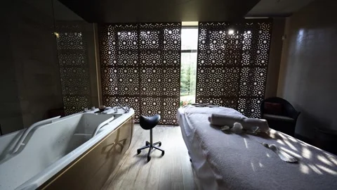 Interior spa room with massage table, hydrotherapy tub, star screen Stock Footage 337263855