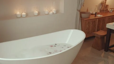 Interior Of SPA Salon With Bathtub Filled With Warm Water With Foam And Flowers 스톡 동영상 302282409