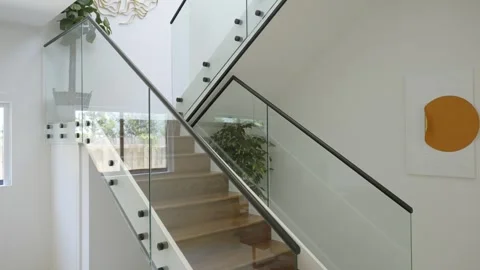 Interior space featuring staircase with wooden steps and metal railing. Glass Stock Footage 294906738