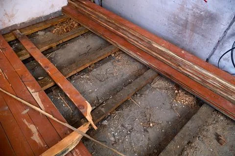 The interior space shows a partially stripped wooden floor, revealing woode.. Stock-Fotos