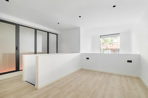 Interior of spacious empty room in a duplex flat. White and clean room with Stock Photos
