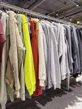 Interior of sporting goods store with bright jackets on hangers showcases m.. Stock-Fotos