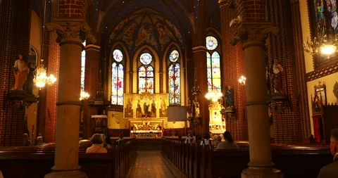Interior of St. John the Baptist Church with Altar and Stained Glass Windows Stock Footage 336998843