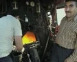Interior of steam train engine room and workers SD Footage