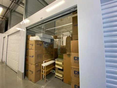 An interior of a storage space unit displaying the boxes at Extra Space Stora Stock Photos