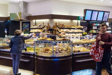 The interior of the store with a large selection of bread, rolls, loaves, cak Stock Photos
