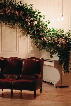 Interior in the studio plant composition of green branches and flowers, piano Stock Photos