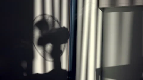 Interior Summer Shadows of Desktop Fan And Blinds Blowing in the Breeze. Stock Footage 54588099