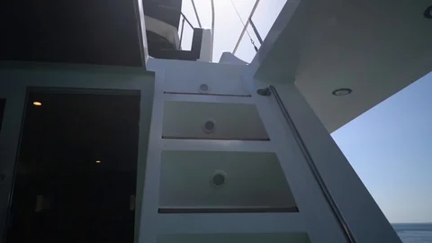 Interior of superb yacht white staircase from cabin upstairs to the open deck to Stock Footage 126214342