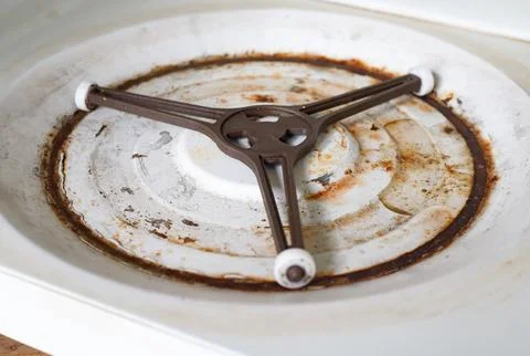 Interior surface of the microwave bottom panel is covered in rust and rot. .. Stock Photos