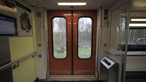 Interior of Swiss double-decker train showing orange automatic doors with Video stock 316630801