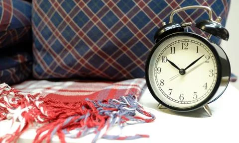 Interior tartan and table clock next to pillows with checkered pattern Stock-Fotos