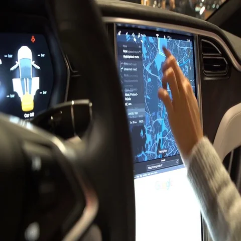 The interior of a Tesla Model X electric car with large touch screen dashboard. Stock Footage