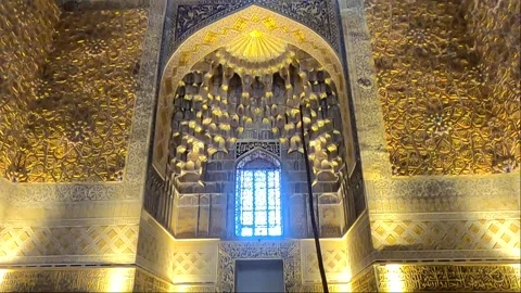 Interior tilt up of Gur-e-Amir Mausoleum gold wall with tourists, Samarkand Stock Footage 336188045