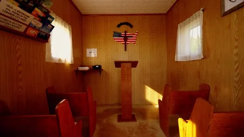Interior of the tiny U.S. Center Chapel with its pews and cross Stock-Footage 345530824