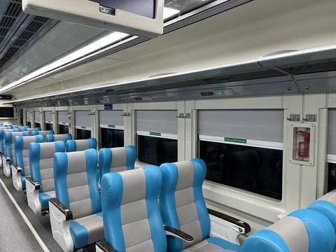 Interior of a train car featuring rows of seats and tables Foto stock