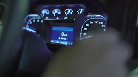 The interior of a truck at night time. The dashboard odometer is lit up. Stock Footage 257693362