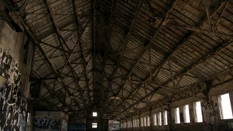 Interior truss ceiling of Abandoned brick building in City Stock Footage 89944884