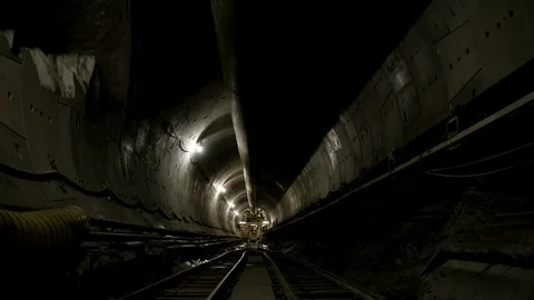 Interior Tunnel - Men exiting vehicle - Wide Shot - Slight Tilt Stock Footage 89985775