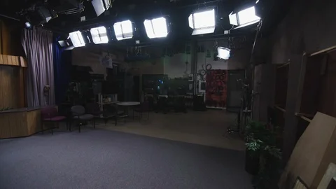 Interior Tv studio with lights, carpet, cameras, movable sets, cables and more Stock-Footage 89504820