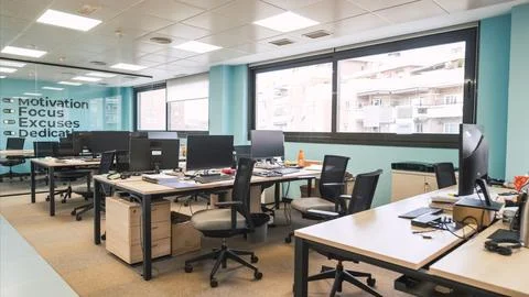 Interior of unorganized creative workspace with computer desks 스톡 사진