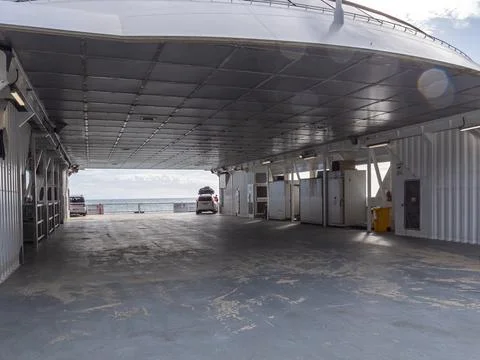 Interior vehicle deck of a passenger ferry looking out towards the open ocean Stockfoto's
