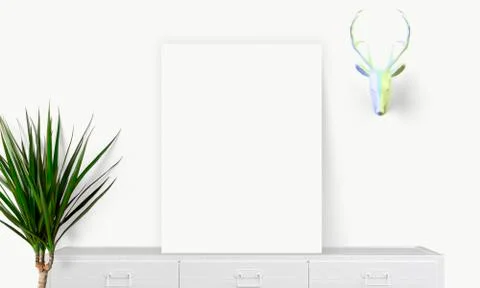Interior vertical rectangular poster mockup standing on the table with plant  스톡 사진