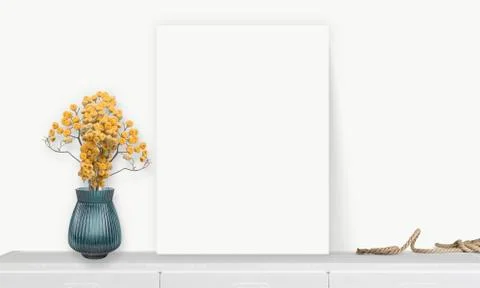 Interior vertical rectangular poster mockup standing on the table with plant  스톡 사진