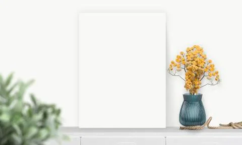 Interior vertical rectangular poster mockup standing on the table with plant  Stock Photos