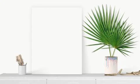 Interior vertical rectangular poster mockup standing on the table with plant  Stock Photos