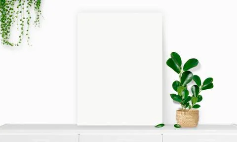 Interior vertical rectangular poster mockup standing on the table with plant  Stock Photos