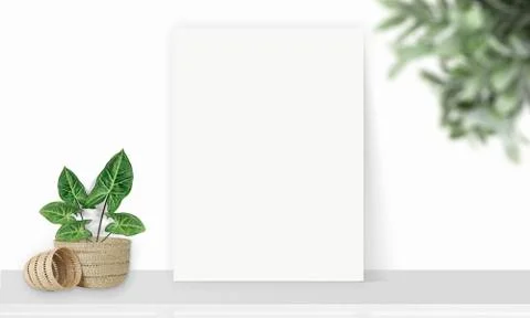 Interior vertical rectangular poster mockup standing on the table with plant  Stock Photos